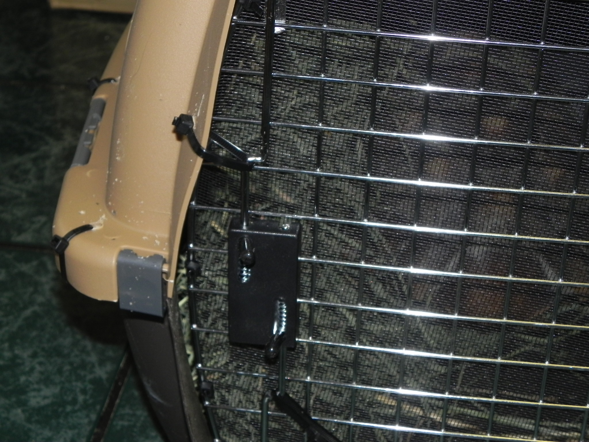 Crate door latch secured